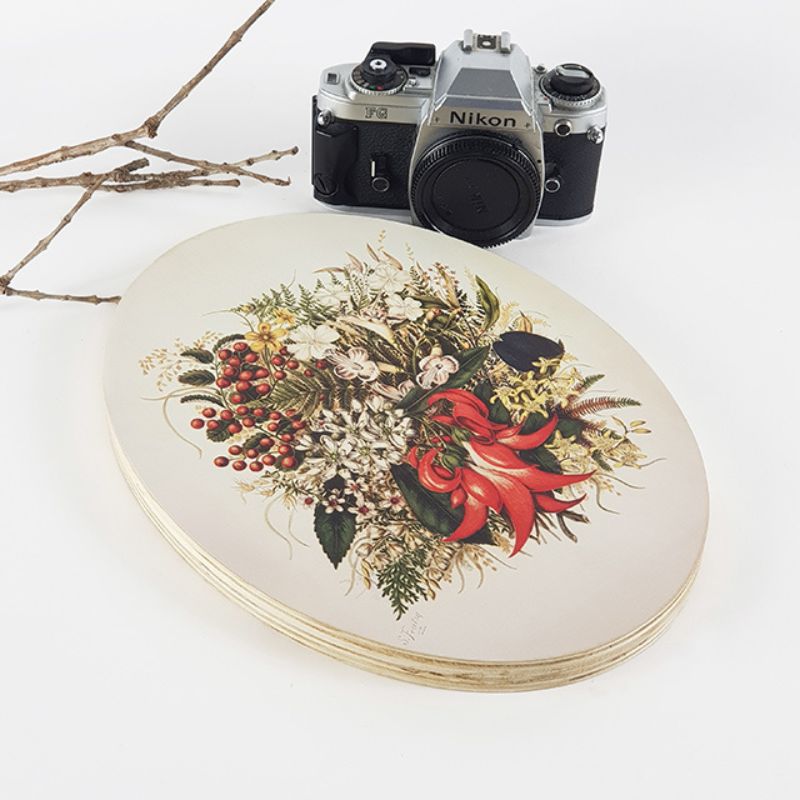 Oval wall art featuring Sarah Featon's vibrant watercolours of New Zealand wildflowers and berries on eco-friendly pine ply.