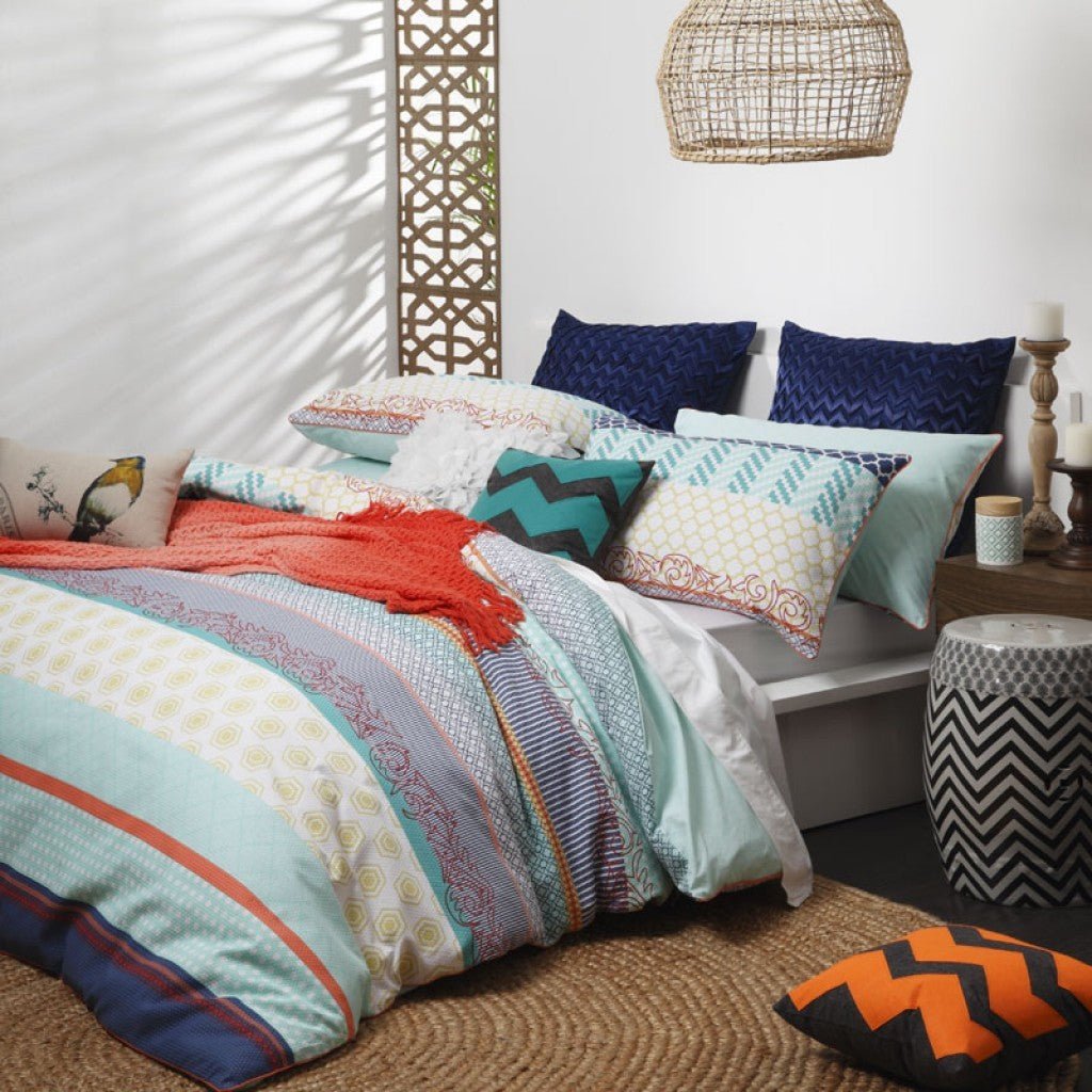 King-sized Shanti Turquoise duvet cover set featuring vibrant geometric print and paisley reverse, perfect for stylish bedding.