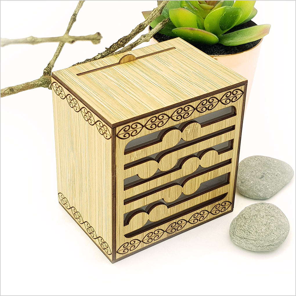 Koru LED tealight candle box made of bamboo veneer, featuring 7 color-changing LED candles, perfect for home decor.