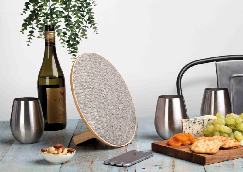 Stylish Lounge Disc Bluetooth Speaker with fabric face, 10W output, 4.5-hour playtime, and wood grain housing.