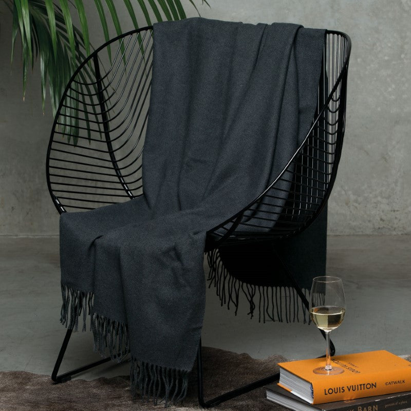 Luxurious 100% Merino wool blanket throw with herringbone weave, soft finish, and elegant fringes for cozy home decor.
