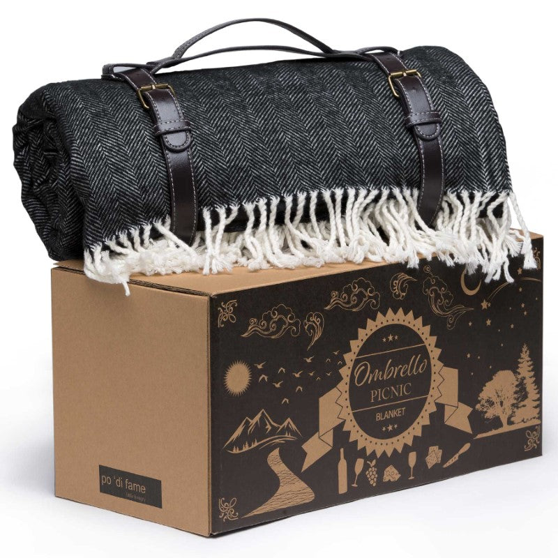 Ombrello Picnic Blanket with herringbone design, waterproof backing, and integrated umbrella hole for stylish outdoor comfort.