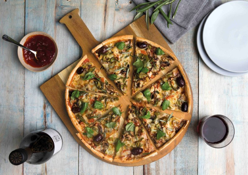 Acacia hardwood pizza peel set with stainless steel cutter, featuring unique wood grain and convenient handle for easy serving.