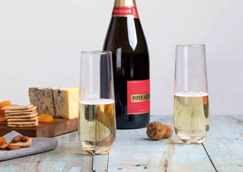 Set of 4 elegant stemless champagne flutes, 250ml capacity, crystal-clear glass, presented in a stylish gift box.