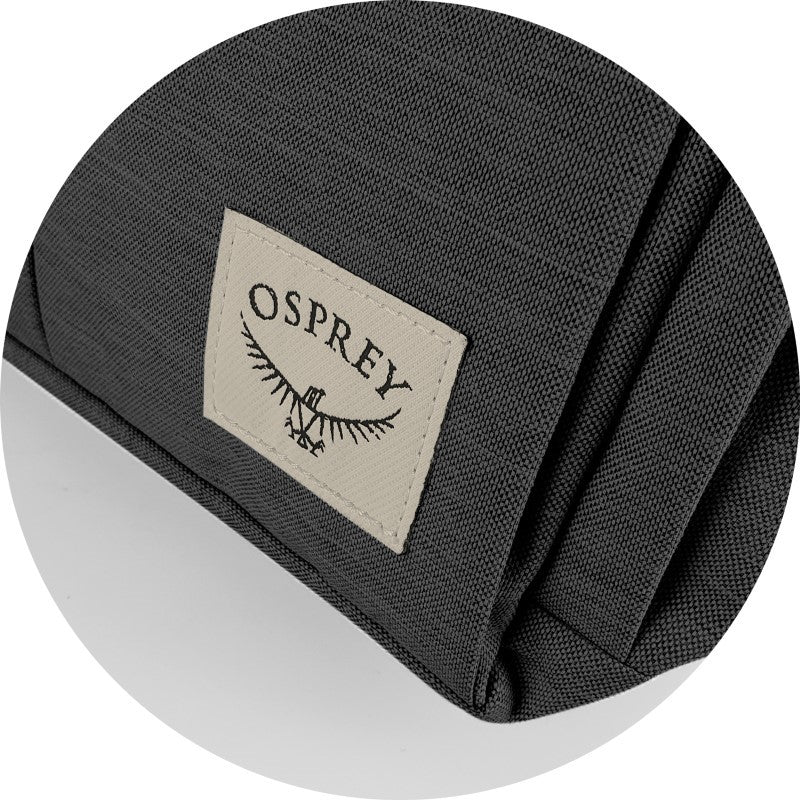 Sleek black Osprey Arcane flap backpack with padded laptop sleeve, eco-friendly design, and multiple organizational pockets.