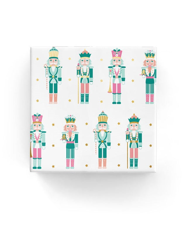 Nutcracker and stars wrapping paper in jade, pink, peach, and gold, perfect for elegant gift presentations.