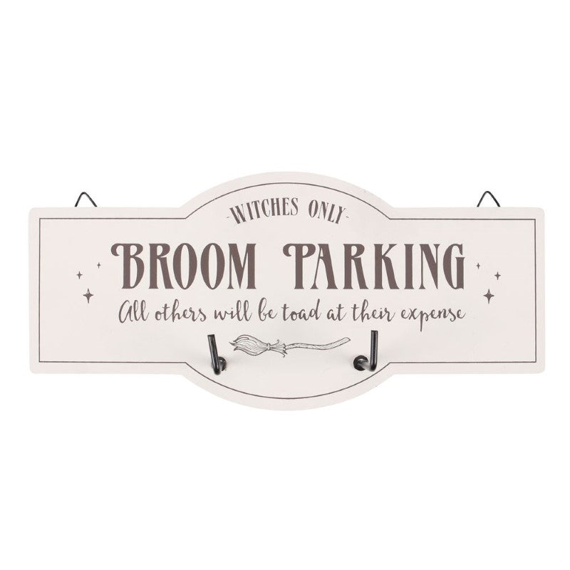 Whimsical wall hook sign with broom illustration and text 'Witches Only - Broom Parking' for organized witchy decor.