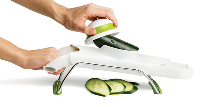 Safety-designed mandoline with four thickness settings and multiple blades for versatile, uniform vegetable slicing.