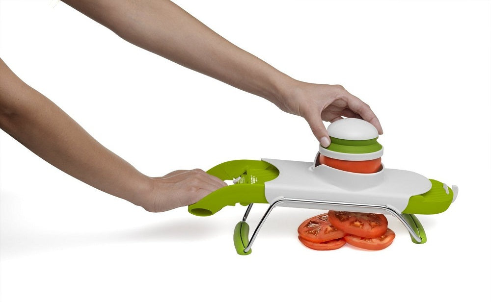 Safety-focused mandoline with pull-and-push design, four thickness settings, and interchangeable blades for versatile slicing.