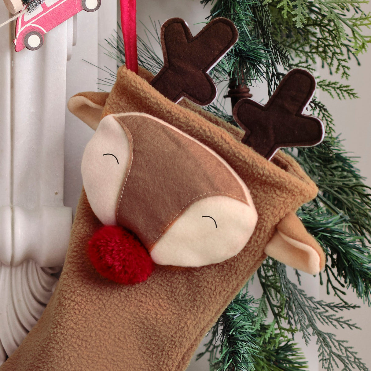 Festive Merry Little Reindeer Christmas Stocking with red pom pom nose, eco-friendly and perfect for family traditions.