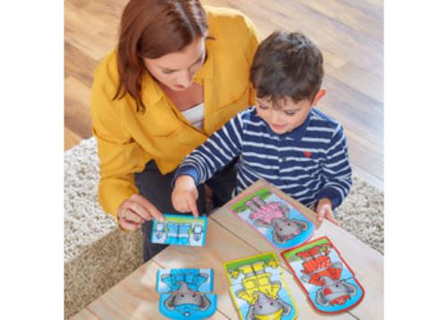 Child interacting with the Orchard Game - Dress Up Nelly, mixing and matching colorful outfits for imaginative play.