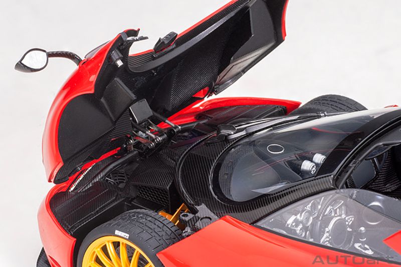 Diecast model of a 1/18 Pagani Huayra Roadster in Rosso Monza Red, featuring detailed interior and exterior design.