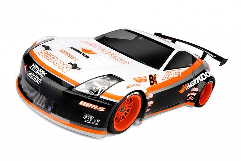 Clear body shell of Nissan 350Z Hankook for 1/10 scale RC cars, featuring decals, rear wing, and light buckets for customization.