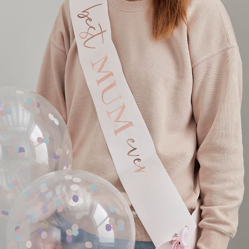 Rose gold "Best Mum Ever" sash in blush pink, featuring scripted writing, eco-friendly packaging, and velvet pink ribbon.