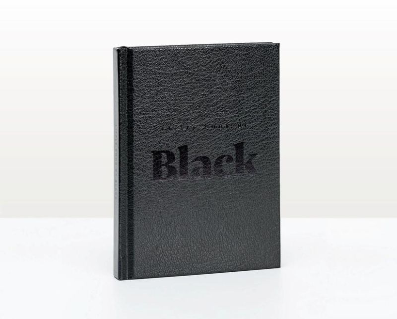 Elegant hardback book featuring captivating black artworks, adorned with foil stamping and a luxurious ribbon marker.