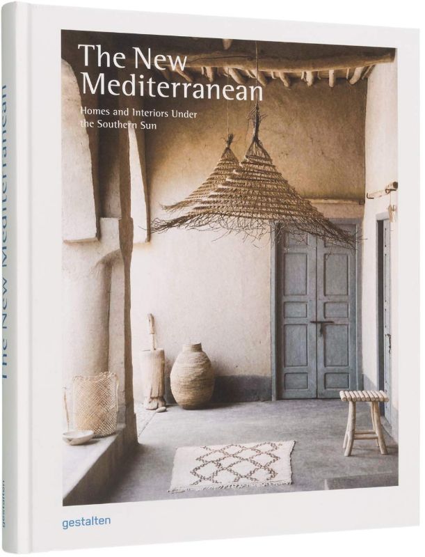 Hardback book 'The New Mediterranean' showcasing minimalistic home decor inspired by warm tones and natural materials.