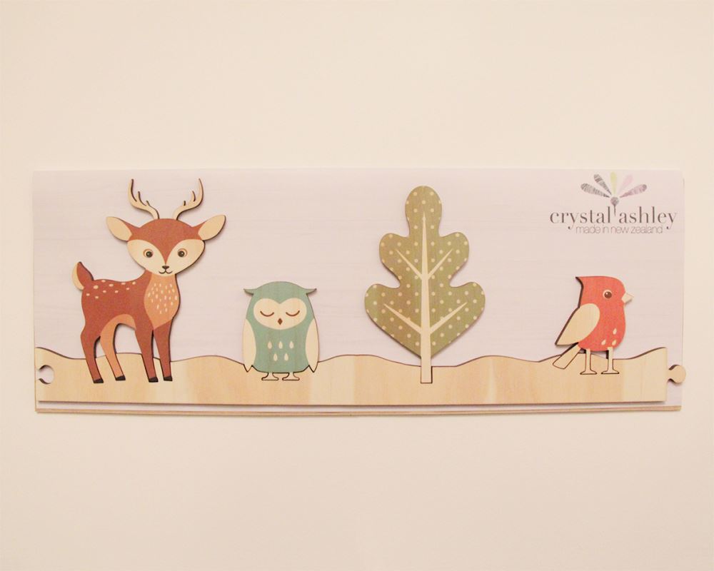 Nature-themed wall art featuring jigsaw strips of trees and deer, crafted from eco-friendly pine veneer.