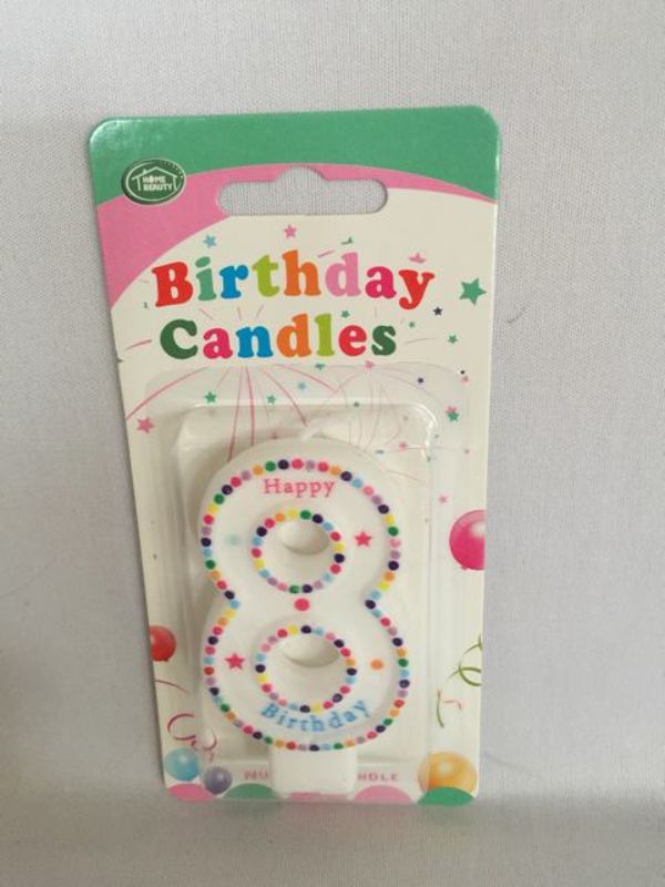 Vibrant set of 12 birthday candles in various colors, perfect for decorating cakes and celebrating special moments.