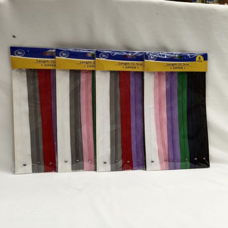 Assorted 22.5cm zippers in a pack of 72, ideal for sewing projects and crafts with a variety of durable options.