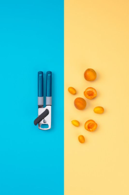 Ergonomic Tasty Can Opener with stainless steel wheel, non-slip handle, built-in bottle opener, and vibrant design for easy use.