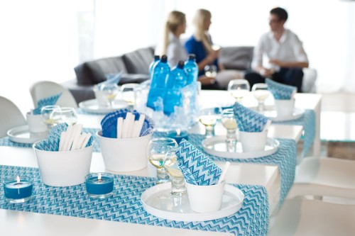 Blue zigzag stripe table cloth and runner, perforated Duni Dunicel, perfect for casual or formal dining occasions.