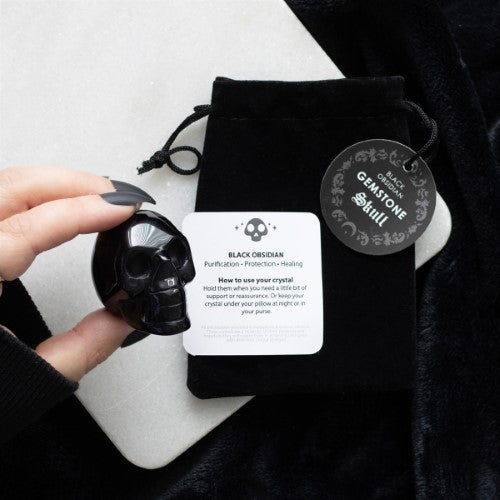 Handcrafted Black Obsidian Crystal Skull, 4x5x2 cm, offering protection and elegance as a unique decor piece or talisman.