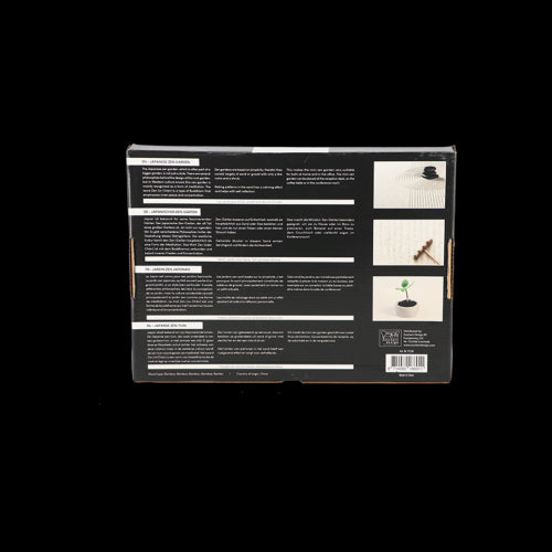 A serene rectangular Zen garden (22x30cm) featuring a concrete tray, white sand, stones, bamboo planter, and wooden rake.