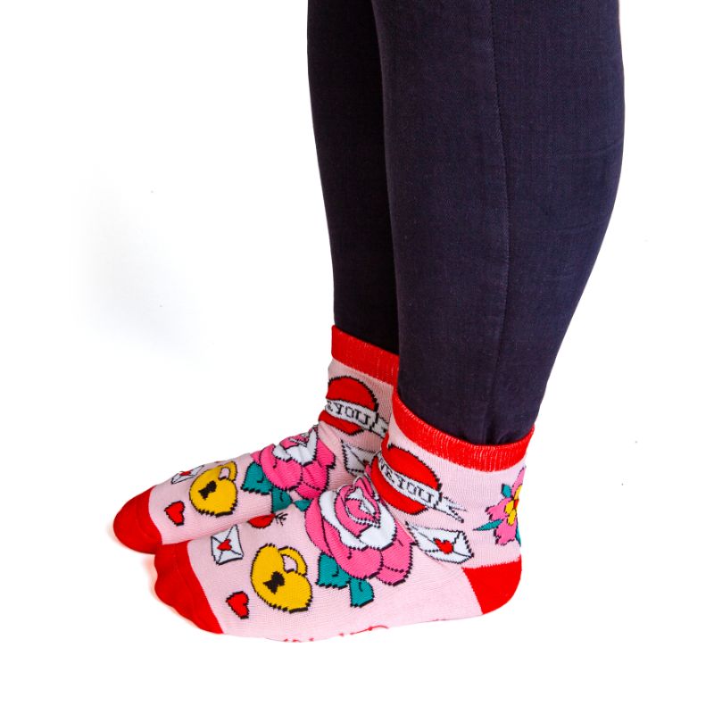 Vibrant pink and red socks with tattoo designs and 'I F*CKING LOVE YOU' ink, perfect for cozy date nights or gifting.