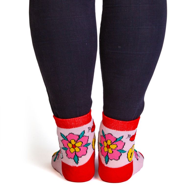 Vibrant pink and red socks with romantic tattoo designs and anti-slip message: "I F*CKING LOVE YOU." Perfect for cozy nights.