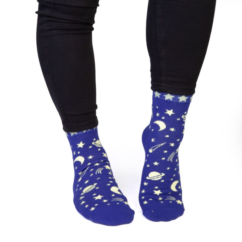 Vibrant socks with stars and planets design, featuring "SPACED OUT" on the bottom for cosmic-themed comfort.