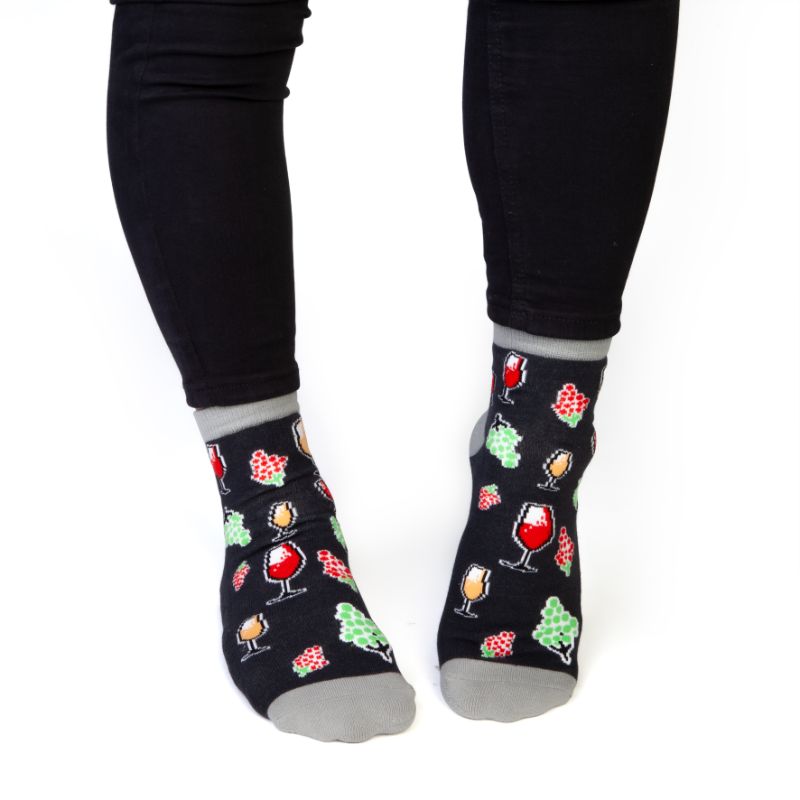 Wine Feet Speak socks, featuring wine glasses and grapes, with 'WINE TIME' phrase; cozy one-size-fits-all design.