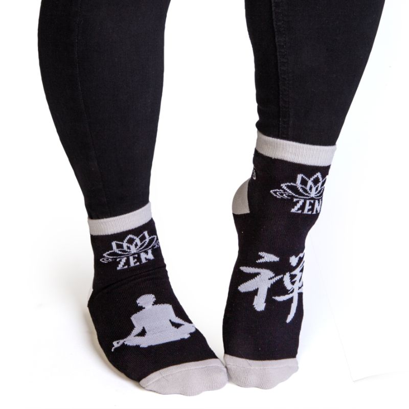 Black socks with grey meditating silhouette and anti-slip print, perfect for comfort and mindfulness in daily wear.