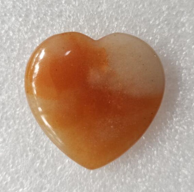 Red Aventurine heart-shaped gemstone (4cm) radiating love and positive energy, ideal for healing and decoration.