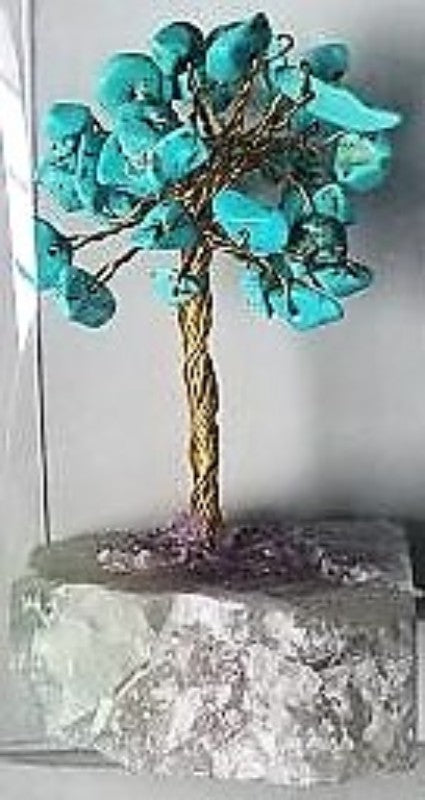 Handcrafted turquoise gemstone tree with a crystal base, promoting positive energy and enhancing home decor.