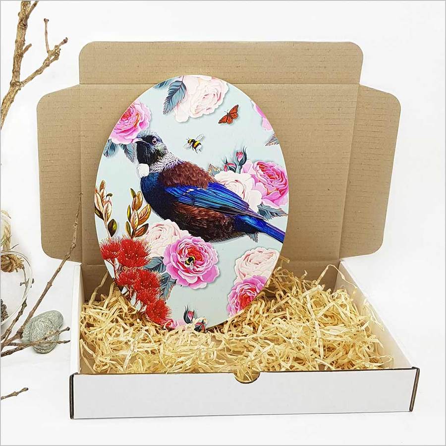 Kiwiana wall art of a Tui bird on eco-friendly pine ply, showcasing vibrant colors and elegant floral design, ready to hang.