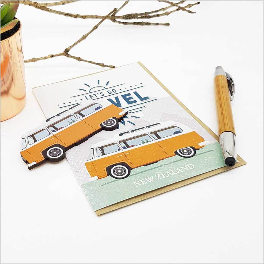 Greeting card featuring "Let's Go Travel" design with embellishments, crafted from premium textured cardstock.