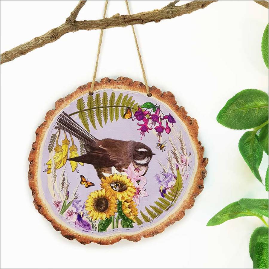 Wood slice wall art featuring a vibrant NZ Fantail bird, perfect for nature lovers and home decor enthusiasts.