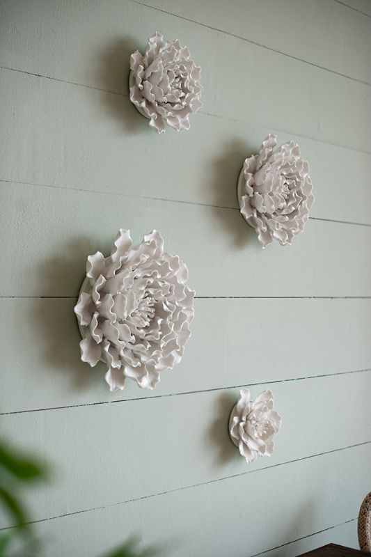 Handmade 15cm ceramic flower wall decor in cream, featuring textured petals for an elegant touch to any space.