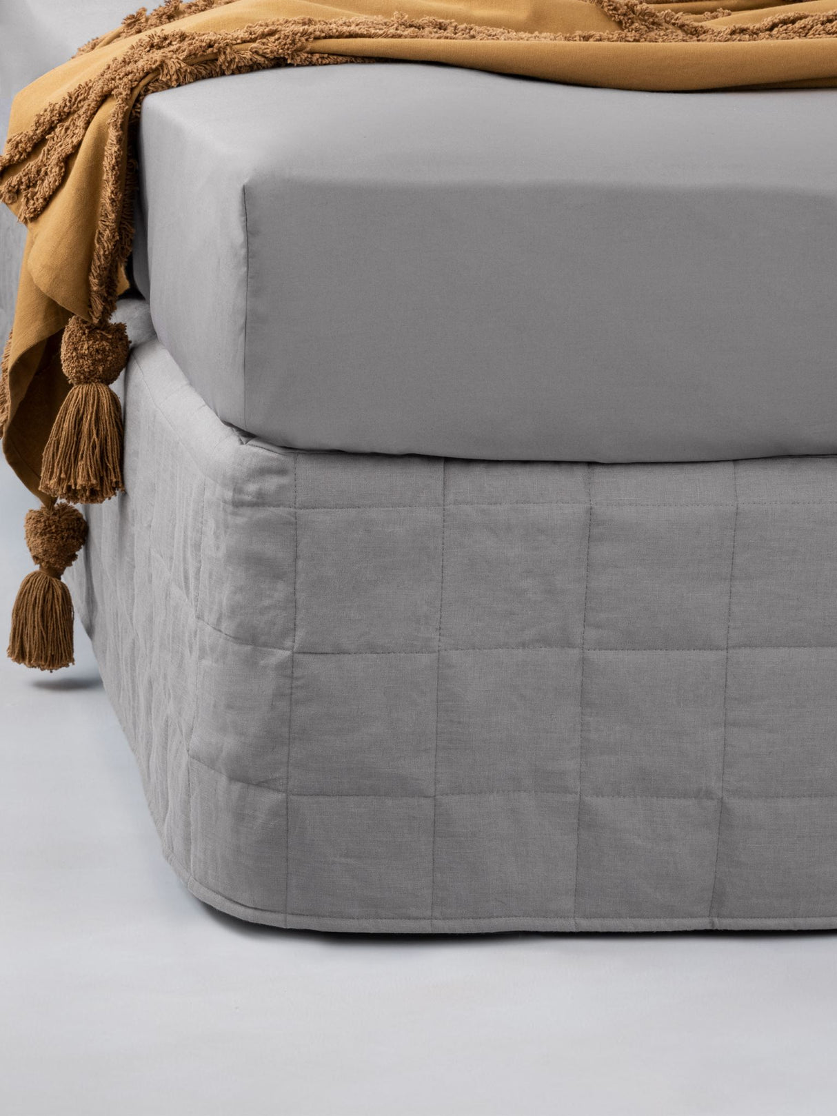 King Quilted Valance in Nimes Ash with quilted linen front and cotton base, enhancing bed decor with timeless elegance.