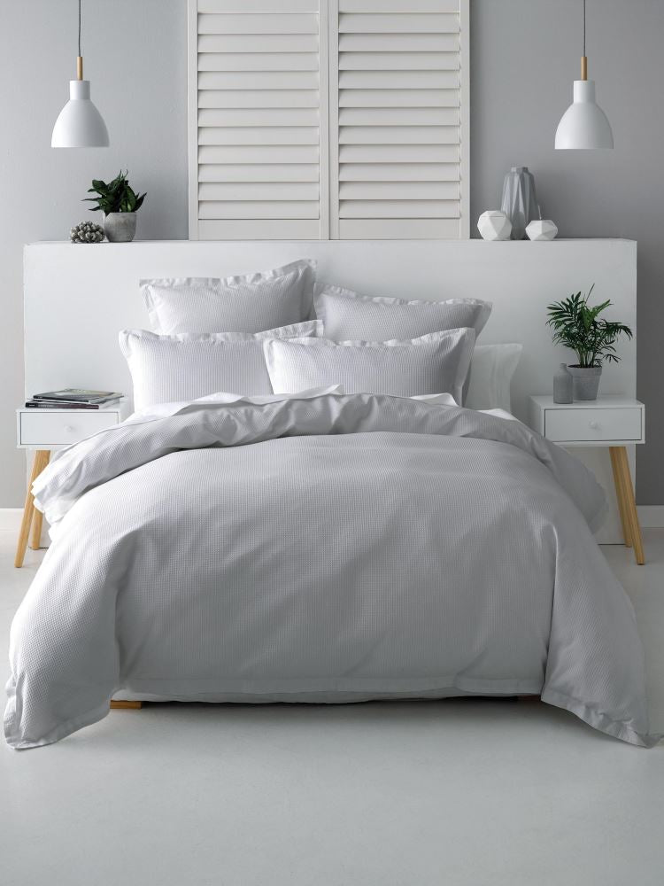 Single bed duvet set in silver with textured waffle design, 100% cotton for comfort and elegance, includes cover and pillowcase.