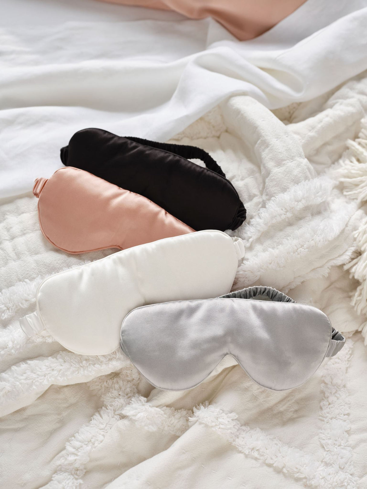 Silk Sleep Mask by Savona in blush, made of pure silk, offers comfort and light-blocking for restful sleep.