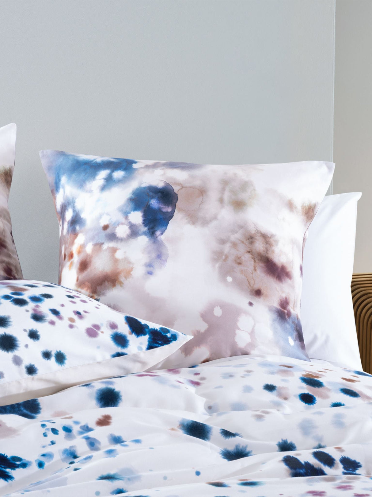 Queen duvet cover set featuring watercolour droplets in soft blues and browns on a white base, crafted from 100% cotton sateen.