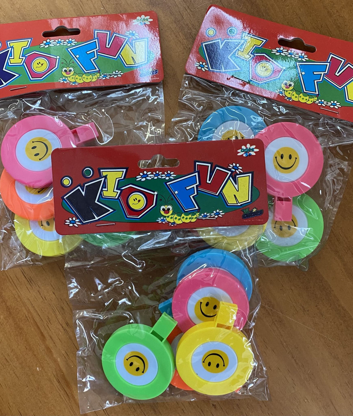 Colorful party favor whistles with a cheerful smile design, great for festive celebrations and fun for all ages.