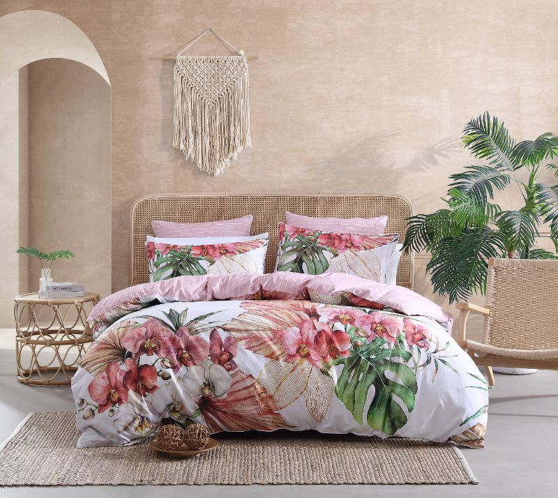 Super King Duvet Cover Set in Orchadia Pink featuring exotic orchids, tropical foliage, and chic white piping for a stylish bedroom.