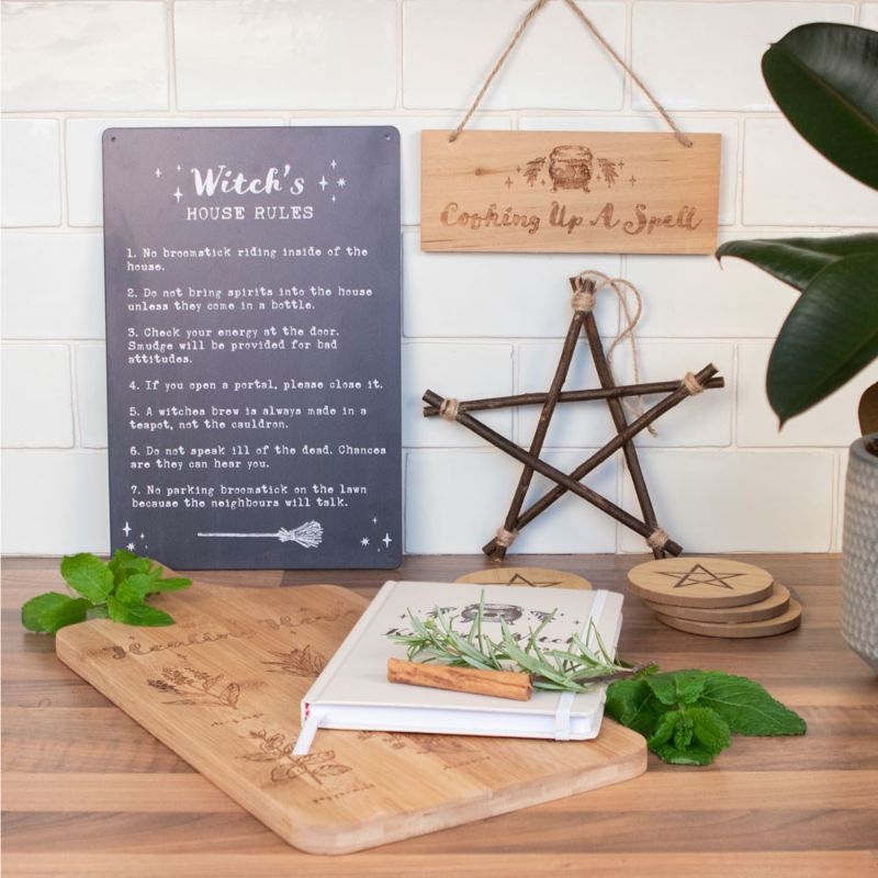 Whimsical metal sign featuring seven humorous witch rules, perfect for enchanting home decor.