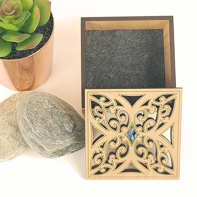 Elegant small square trinket box made from NZ veneer with a beautiful paua inlaid design, ideal for storing jewelry and keepsakes.