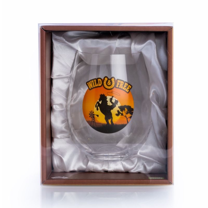 Hand-blown stemless wine glass with cowboy silhouette and 'Wild & Free' lettering, perfect for rustic decor and wine lovers.
