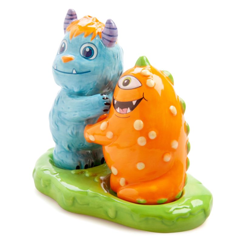 Ceramic salt and pepper shakers shaped like playful Monsterlings Roary and Borg, included with a green slime holder.