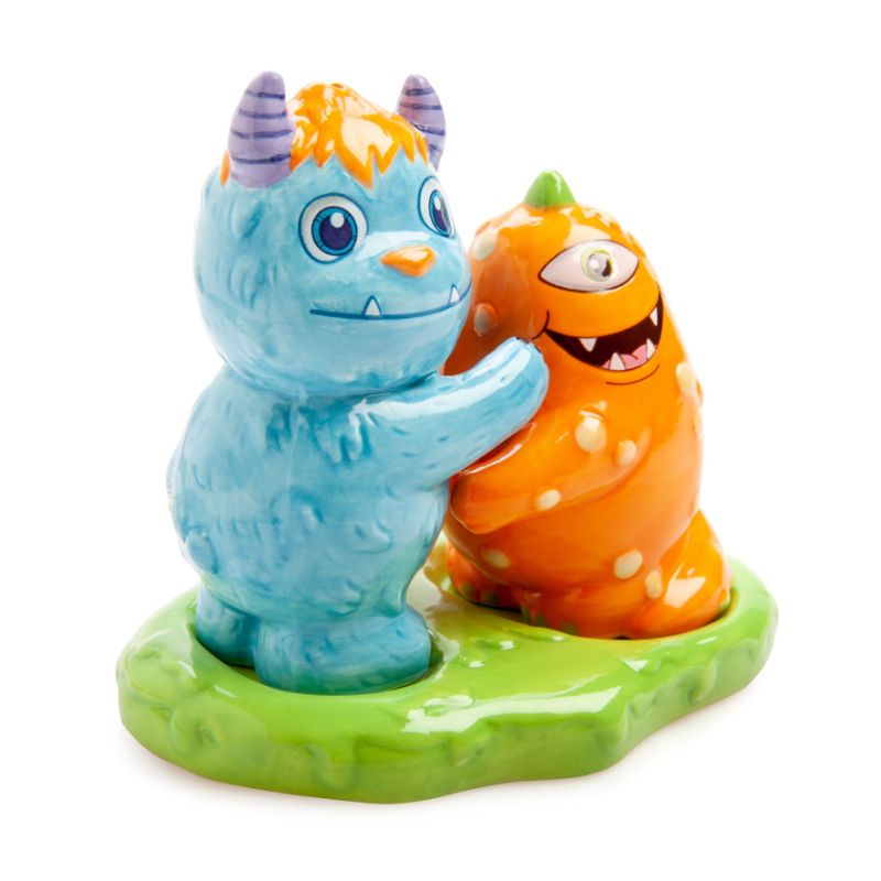 Adorable ceramic salt and pepper shakers shaped like Monsterlings, with a fun green slime holder for display.