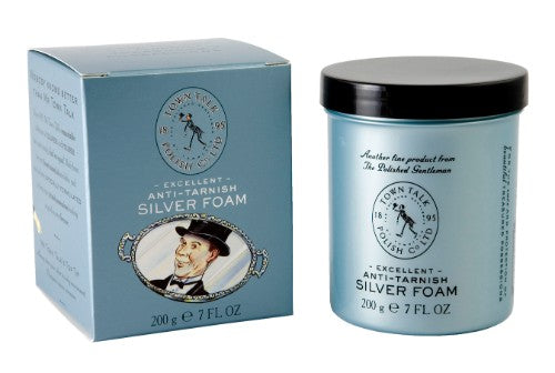 A bottle of Silver Cleaning Foam with sponge applicator for restoring tarnished silverware and decorative pieces.